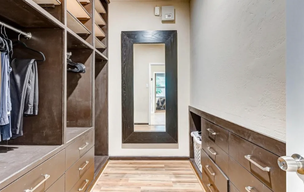 Custom walk-in closet with wood shelves and dresser drawers